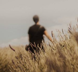 Man sitting outdoors reflecting during addiction recovery